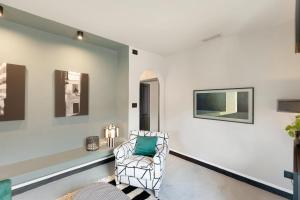 a living room with a chair and a couch at Torri e tramonti in Albenga