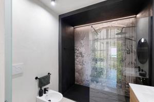 a bathroom with a shower with a toilet and a sink at Torri e tramonti in Albenga +20 photos