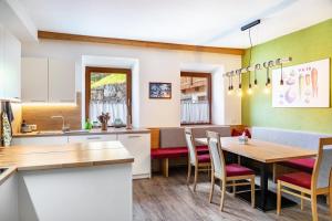 a kitchen and dining room with a table and chairs at A Nett’s Nest - Haus in Hainzenberg