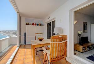 a dining room with a table and chairs and a balcony at Apartment Boulevard 105 in Estepona