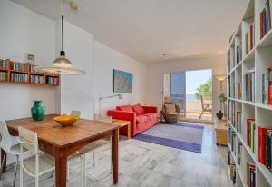 a living room with a table and a red couch at Apartment Boulevard 105 in Estepona