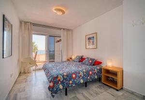 a bedroom with a bed and a view of the ocean at Apartment Boulevard 105 in Estepona +5 photos