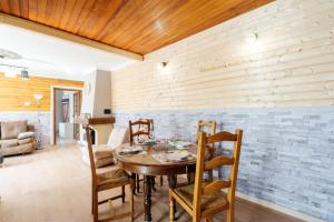 a dining room with a wooden table and chairs at Gîte Zen Attitude in Saint-Martin-sur-le-Chambre
