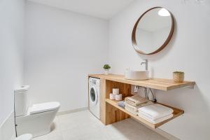 a bathroom with a washing machine and a mirror at Casa Ann in Arrecife +13 photos