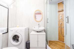 a bathroom with a washing machine and a sink at Gîte Zen Attitude in Saint-Martin-sur-le-Chambre +18 photos