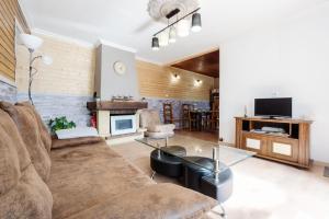 a living room with a couch and a glass table at Gîte Zen Attitude in Saint-Martin-sur-le-Chambre