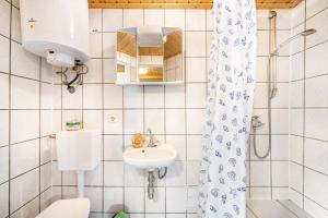 a bathroom with a sink and a toilet and a shower at Bungalow 13 - Finnhütte in Niesky +11 photos