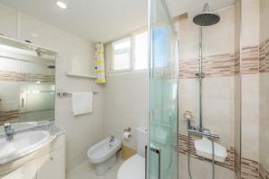 a bathroom with a shower and a toilet and a sink at Casa Laura in Cala Ratjada +17 photos