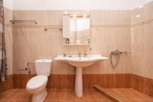 a bathroom with a sink and a toilet and a mirror at Villa Nikolaos in Rhodes Town +14 photos