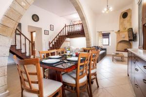 a kitchen and dining room with a table and chairs at Villa Nikolaos in Rhodes Town