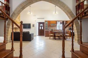 an archway in a living room with a dining room at Villa Nikolaos in Rhodes Town
