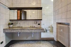 a bathroom with two sinks and a toilet at Appartamento Il Parco Cernobbio in Cernobbio +25 photos
