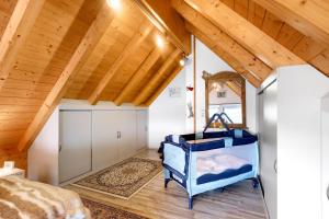 a bedroom with a bed and a wooden ceiling at Ferienwohnung am Rosenberg in Stockach