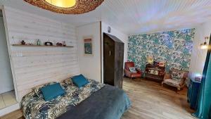 a bedroom with a bed with blue pillows on it at Villa Esterel, Pour 14 Pers in La Faute-sur-Mer