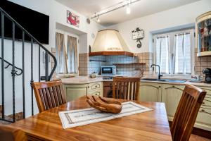 a kitchen with a wooden table with a statue on it at Emma Home in Mezzolombardo