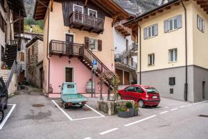 a car parked in a parking lot in front of a building at Emma Home in Mezzolombardo