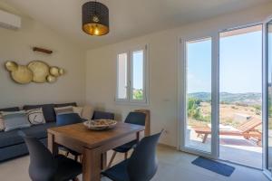 a living room with a table and a couch at Il Sughereto In Vigna in Aglientu +63 photos