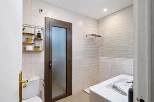 a bathroom with a shower and a toilet and a sink at Alfons I in Puigcerdà +24 photos