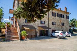 a building with cars parked in front of it at Vecchio Molino in Gavorrano