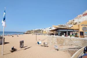a view of a beach with people and the ocean at Hanna's Sunny Apartment in Albufeira