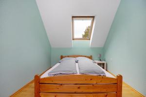 a bed in a blue room with a window at Ferienwohnung Goelz in Bad Schussenried