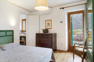 a bedroom with a bed and a dresser and a window at Villa Il Cortivo 81 in Fratta