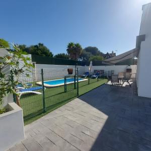 a patio with a fence and a swimming pool at Casa Alex 1 in Zahora