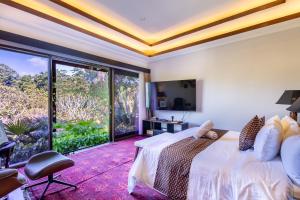 a bedroom with a bed and a large window at Villa Sulastri - Tanah Lot in Tanah Lot +63 photos