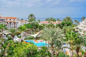 an aerial view of a resort with a pool and palm trees at 1bed Duplex Las Americas in Playa de las Americas