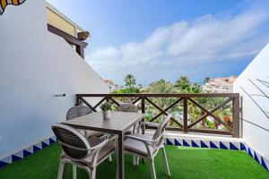 a patio with a table and chairs on a balcony at 1bed Duplex Las Americas in Playa de las Americas