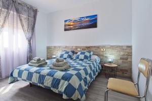 a bedroom with a bed with towels on it at Pisos Leopoldo - Casaio in Casayo
