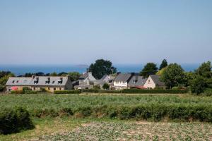 a village with houses and a field of crops at Gîte Kerli cosy 2kms plage in Trévou-Tréguignec