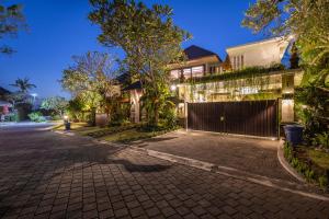 a house on a street at night with lights at Villa Sulastri - Tanah Lot in Tanah Lot