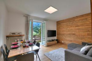 a living room with a table and a couch at Starkeeper Apartment - Happy Rentals in Pragelato +15 photos