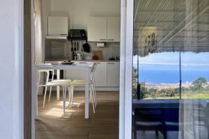 a kitchen with a table and chairs and a window at Sea view avocado Finca Ten Days in La Orotava