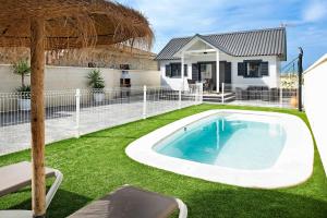 a swimming pool in the yard of a house at Casa Manoli in Hozanejos