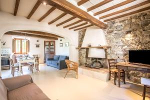 a living room with a blue couch and a stone fireplace at Appartamento Gemma Verde-tavoleto in Castiglione dʼOrcia