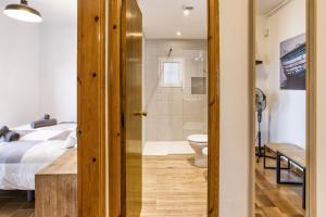 a bedroom with a bed and a bathroom with a toilet at Casa Con Vistas Aiguablava in Tamariu +26 photos