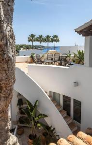 a view from the balcony of a house with stairs and chairs at La Chamade Cala Dor in Santanyi