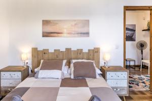 a bedroom with a large bed with two night stands at Casa Con Vistas Aiguablava in Tamariu