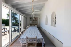 a dining room with a table and chairs on a porch at La Chamade Cala Dor in Santanyi