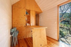 a wooden cabin with a counter in a room with a window at Cabanas do Alto da Coutada in Ponte de Lima +16 photos