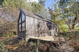 a small wooden house in the middle of a forest at Cabanas do Alto da Coutada in Ponte de Lima