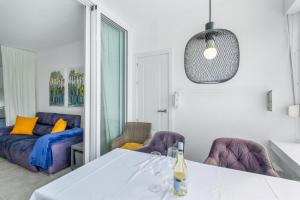a living room with a table and a couch at Vistas al atlantico in Puerto Rico de Gran Canaria