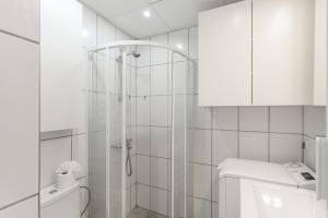 a white bathroom with a shower and a toilet at Vistas al atlantico in Puerto Rico de Gran Canaria +18 photos