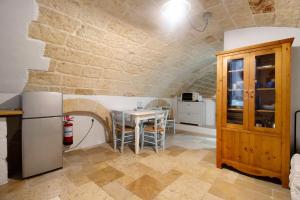 a kitchen with a table and a refrigerator at Il Pescatore in Monopoli