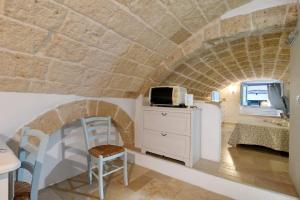 a kitchen with a room with a stone wall at Il Pescatore in Monopoli