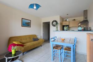 a living room with a couch and a table at T2 avec terrasse proche plages in Pléneuf-Val-André
