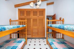 a room with two bunk beds and a door at Villa Solivent in Es Mercadal +22 photos