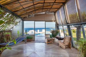 a patio with a hammock and a view of the ocean at Villa Solivent in Es Mercadal